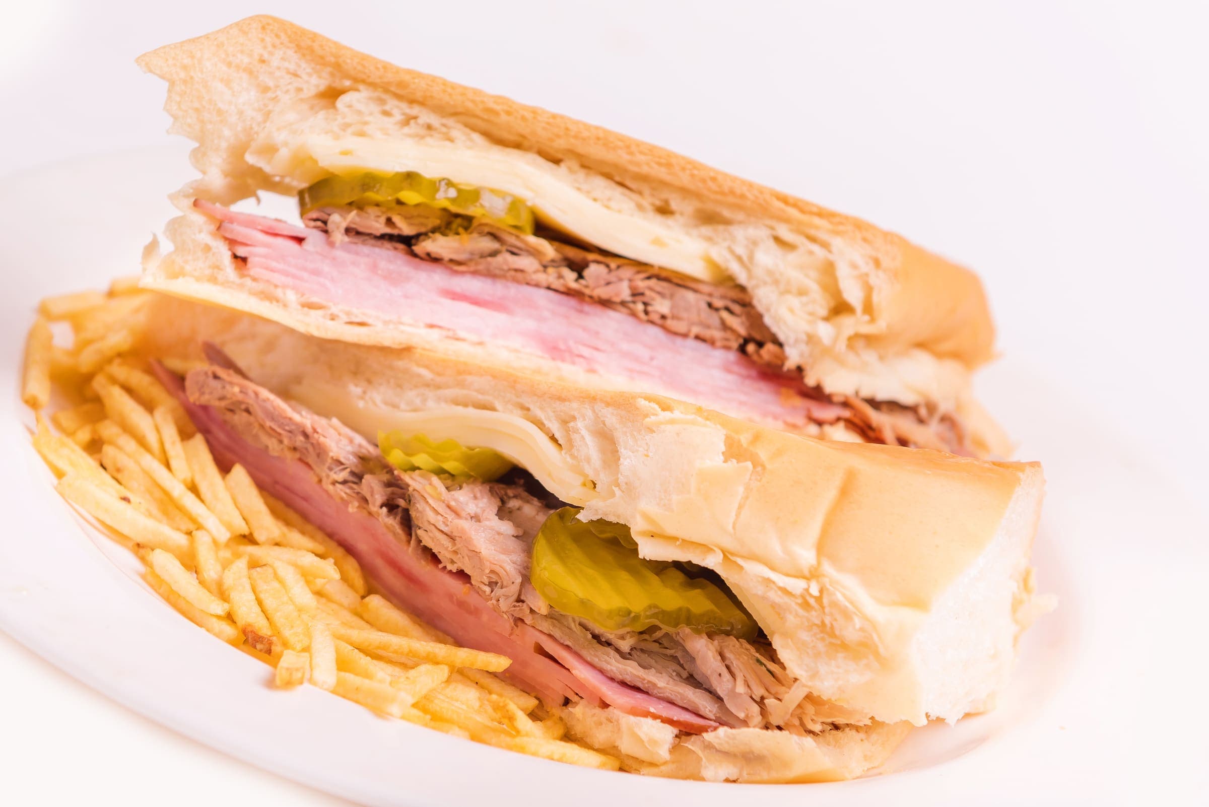 A Cuban sandwich, pressed and cut on the diagonal