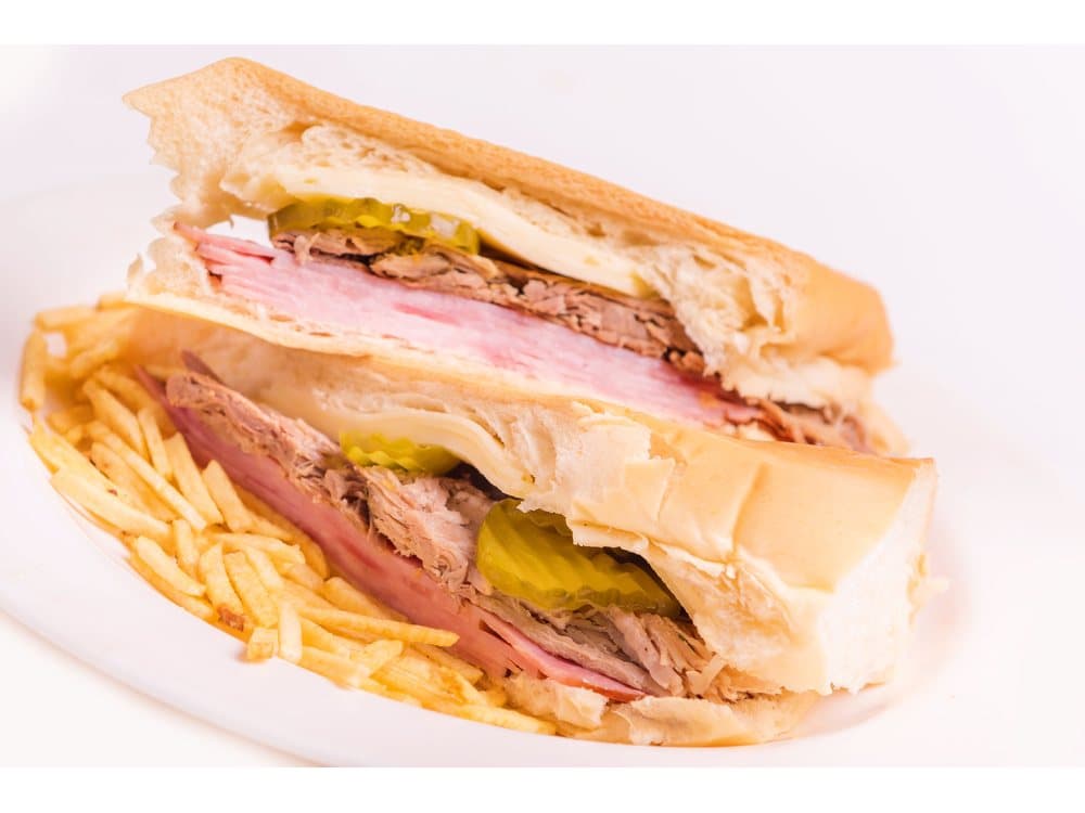 Sandwich Cubano — Cuban bread, ham, Swiss cheese, roast pork, mayonnaise, mustard and pickles