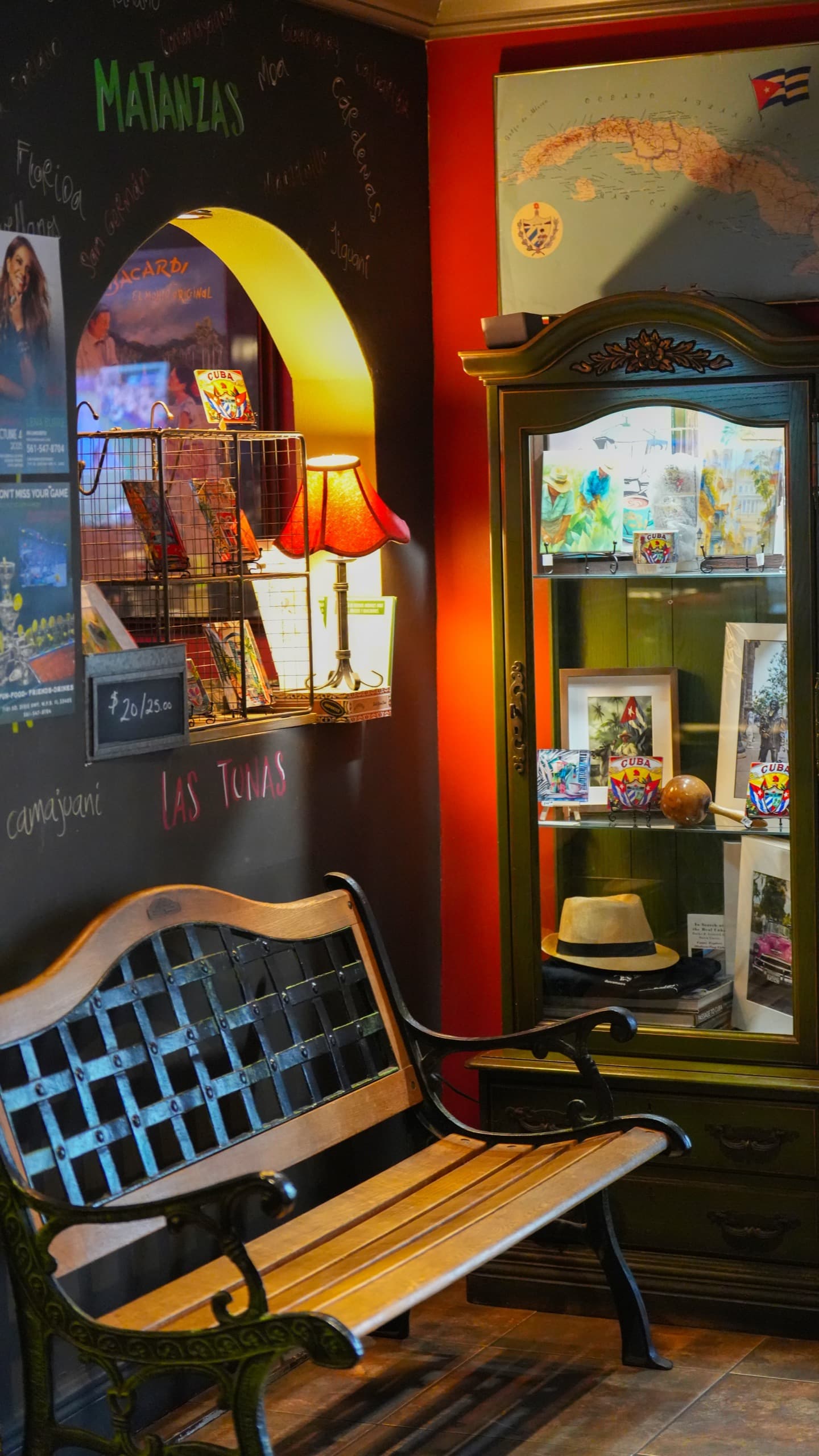 The entrance bench beside the antique mirrored cabinet and the map of Cuba