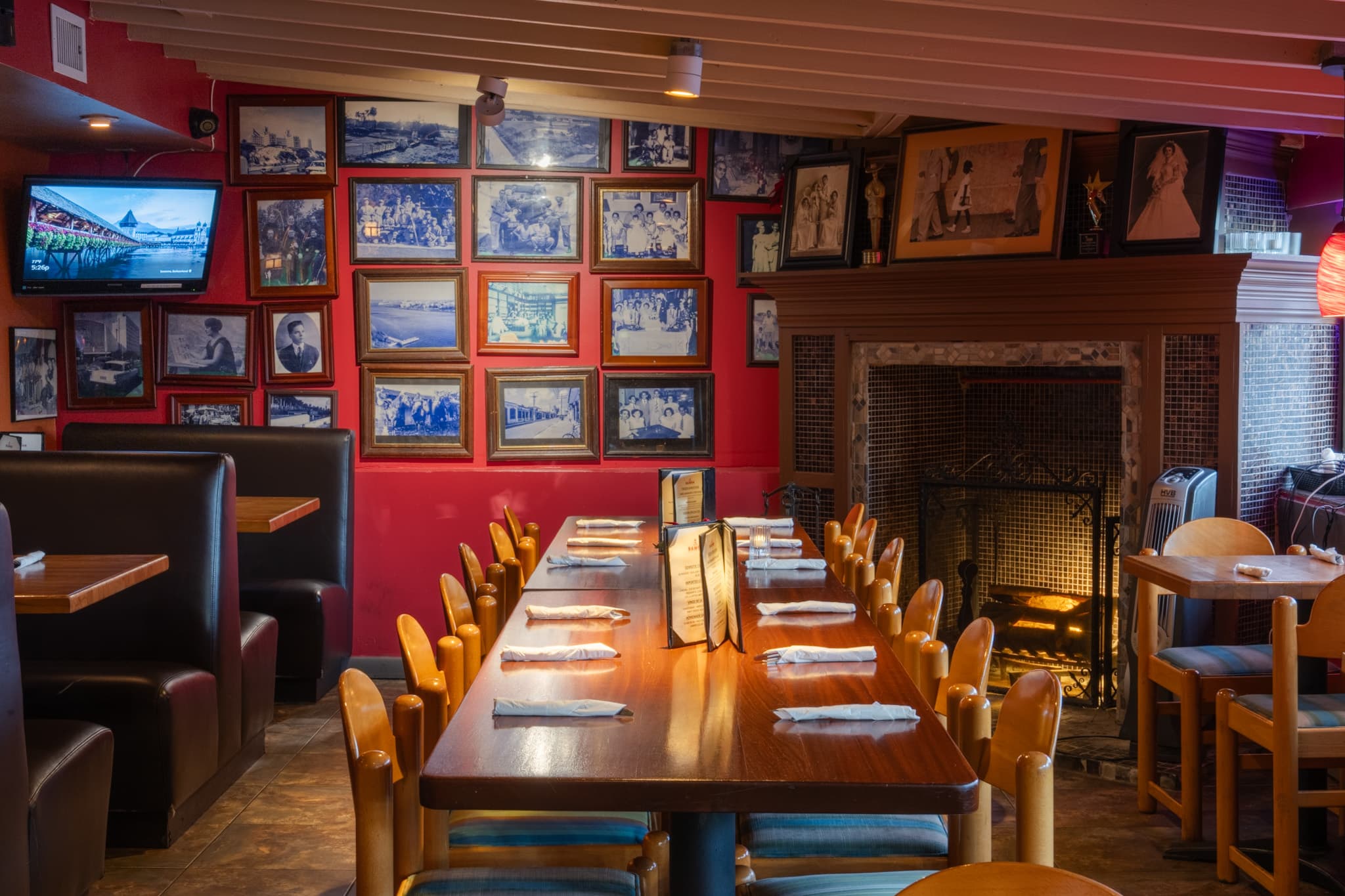 The long communal table by the fireplace