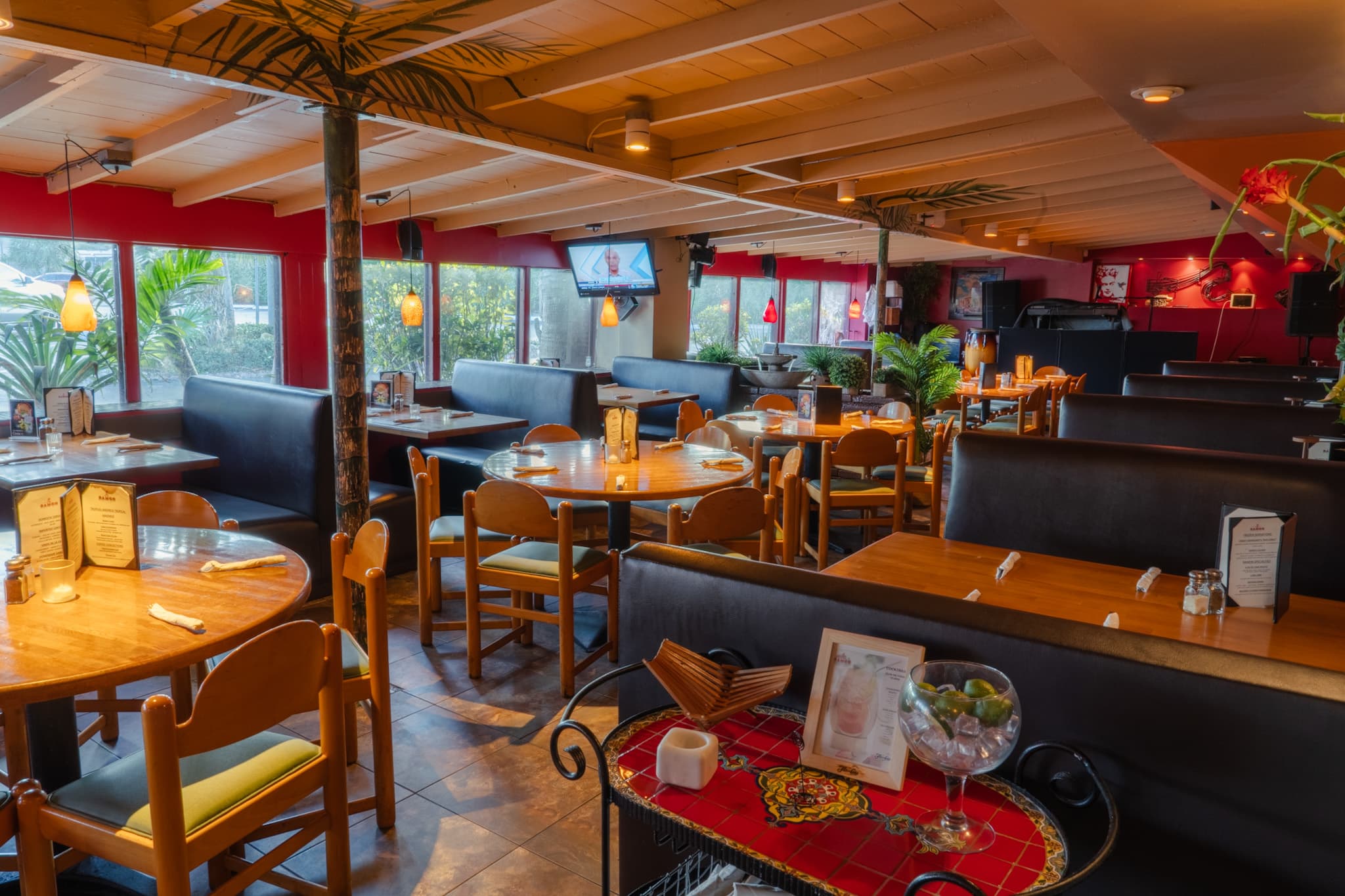 Booths and palms in the main dining room