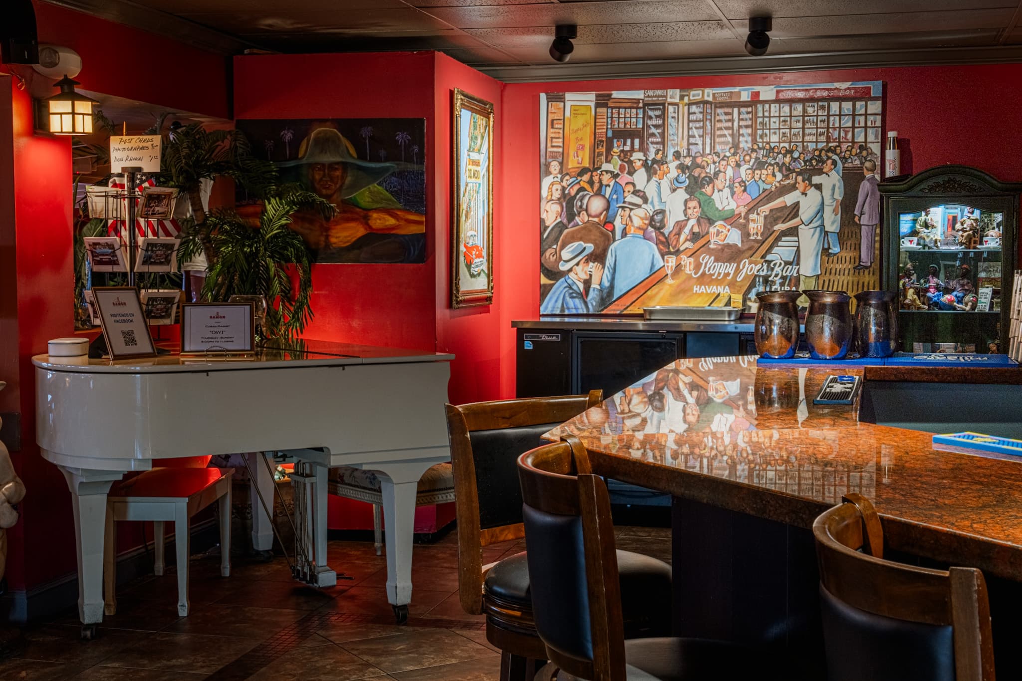 The piano beside the painted mural of a Havana cigar factory